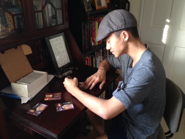 Brandon signs his Fly Molo character trading cards.